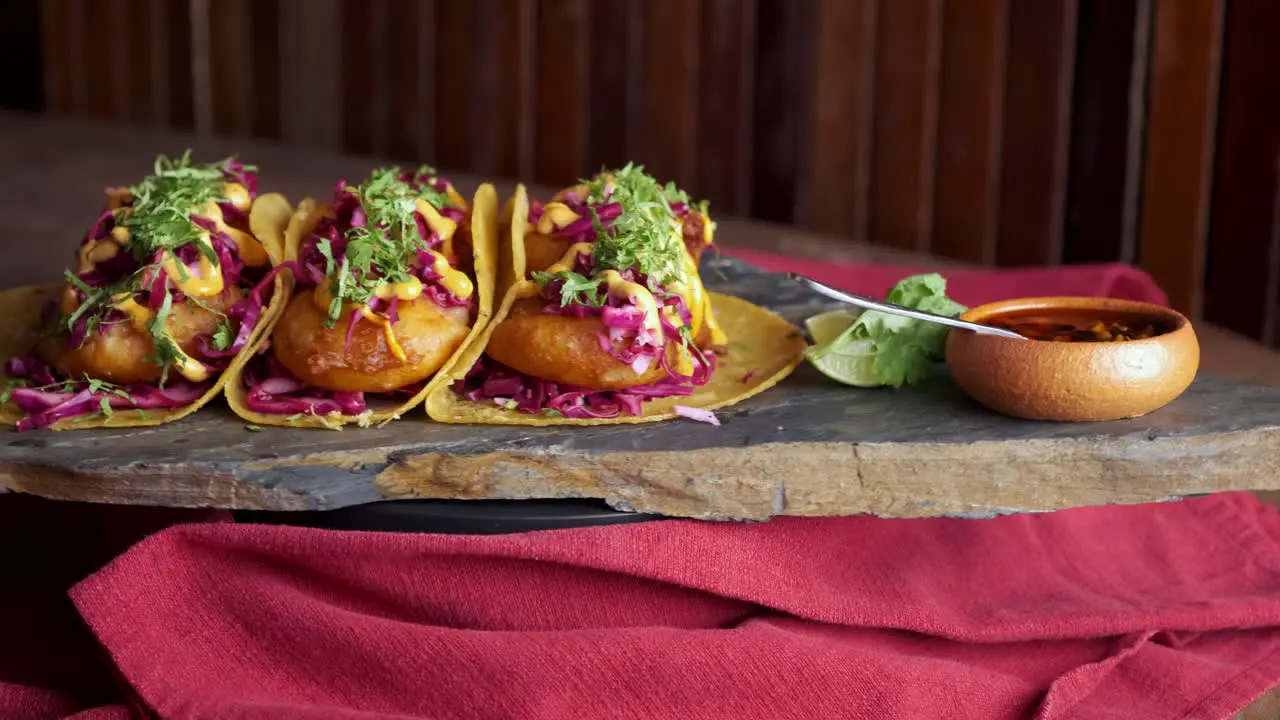 footage of Shrimp tacos with garnish rotating on a plate