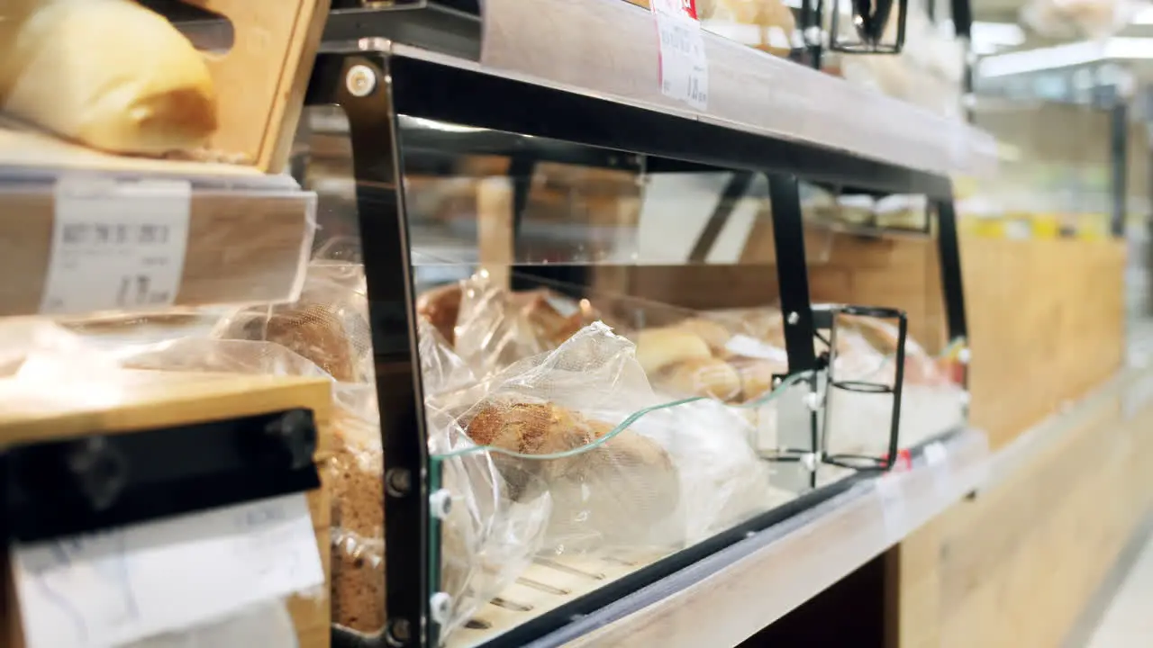 Close up of a man grabbing a packed sandwich