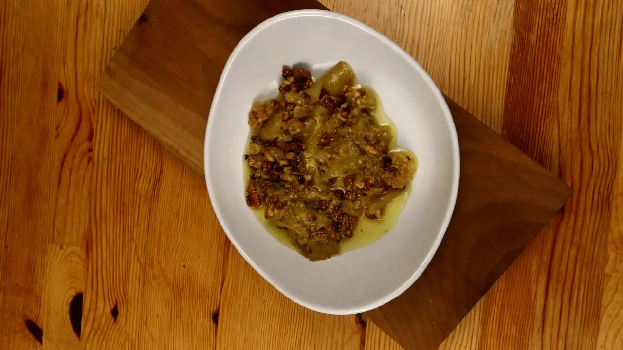 the chef is pouring sauce on the yogurt in the plate slow motion