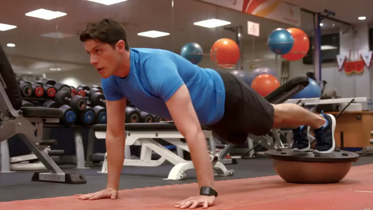 Man doing plank position on bosu ball