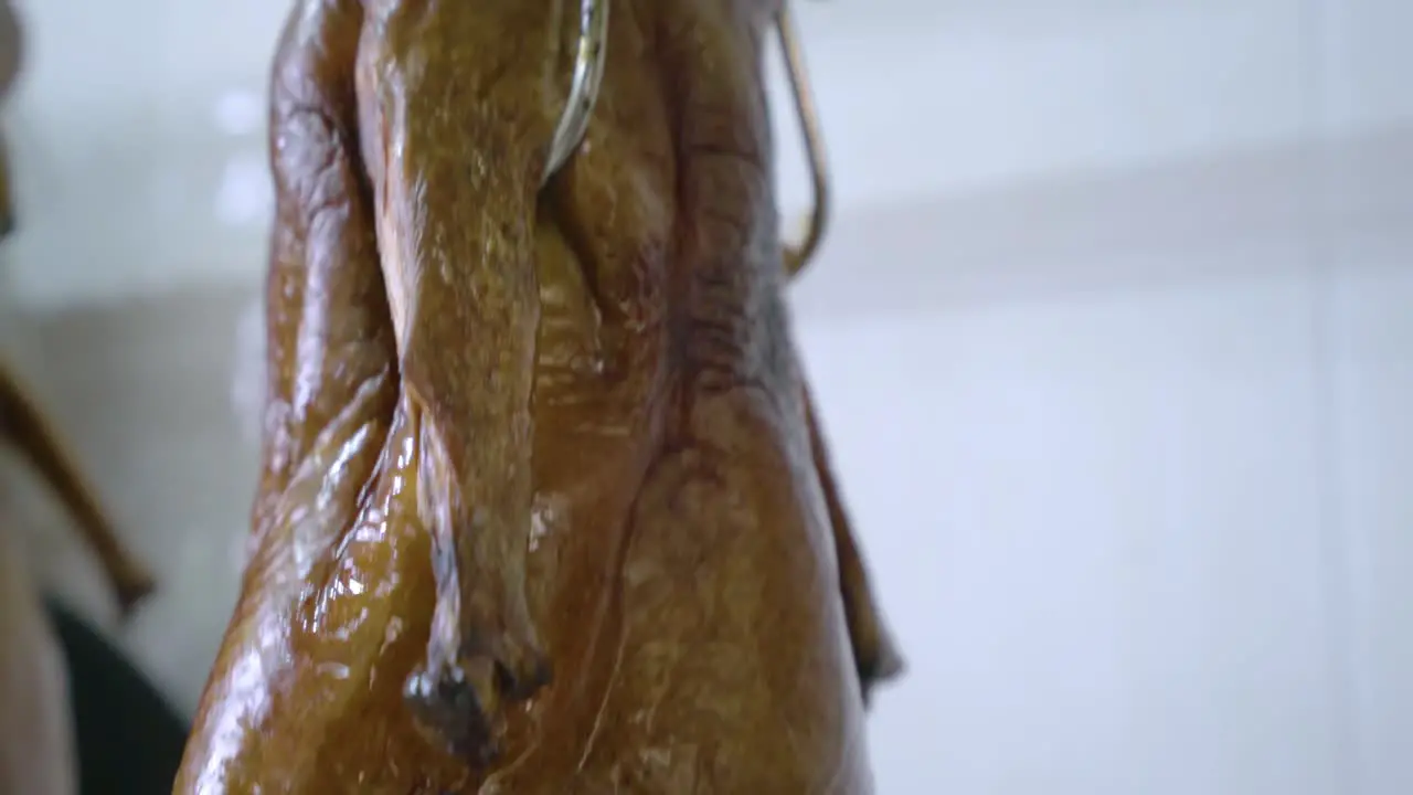 Crispy Roasted Duck Hanging Inside The Kitchen Of A Chinese Restaurant In Guangzhou China tilt-up shot