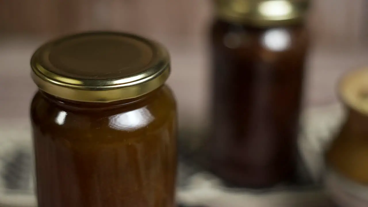 Close up of rotating mason jar of peach jam