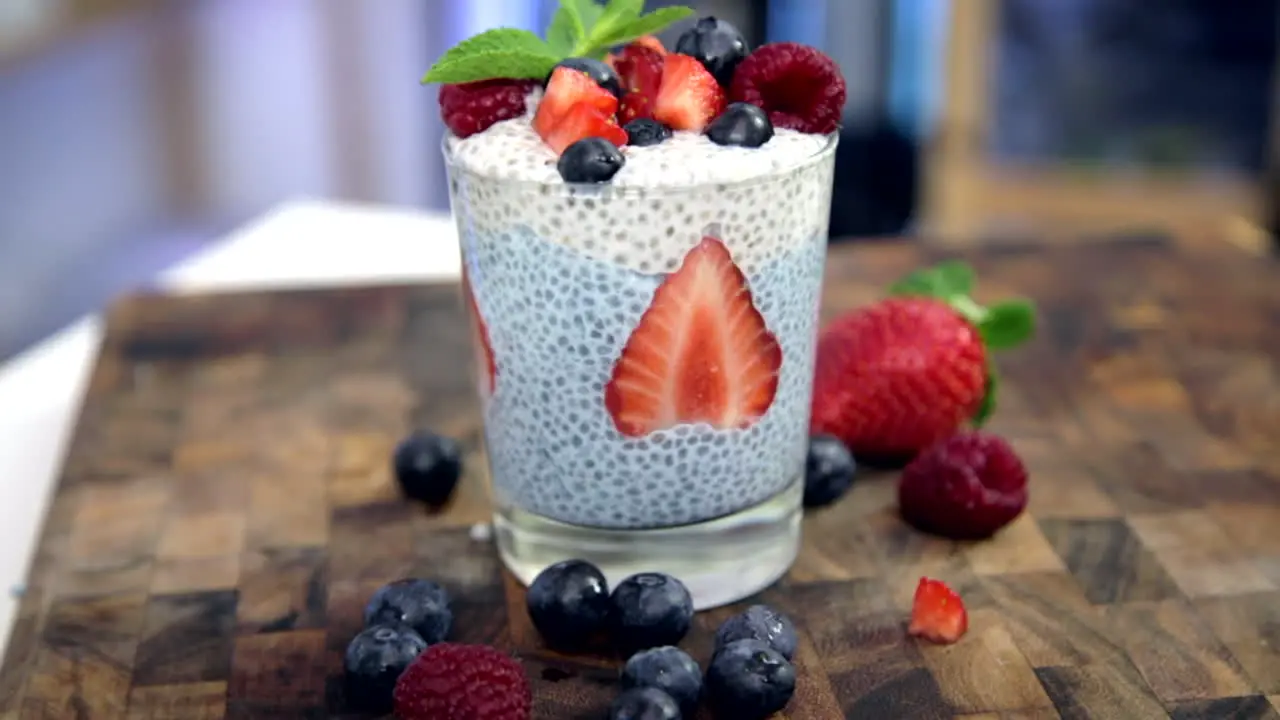 blue spirulina chia pudding with white coconut chia pudding and strawberries and blueberries plus raspberries healthy food option choice