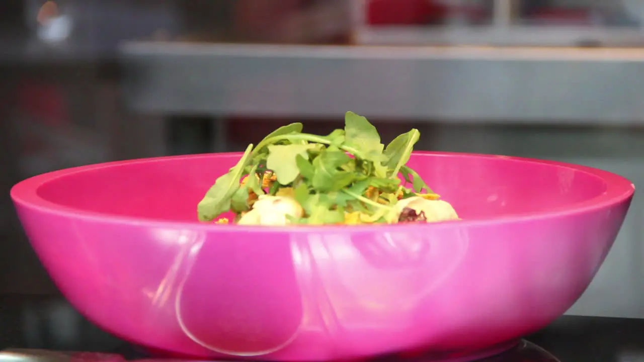 Caterer preparing salad with arugula