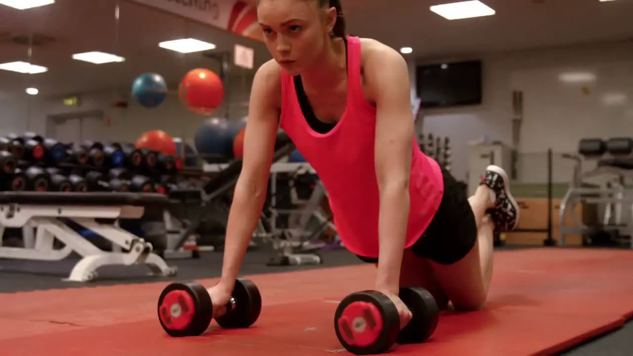 Woman doing push ups in gym