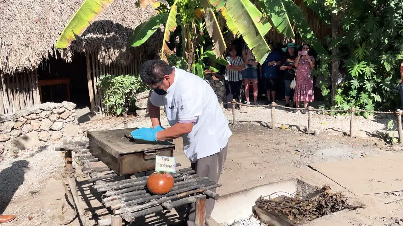 slow motion shot of chefs cleaning the pan of the cochinita pibil