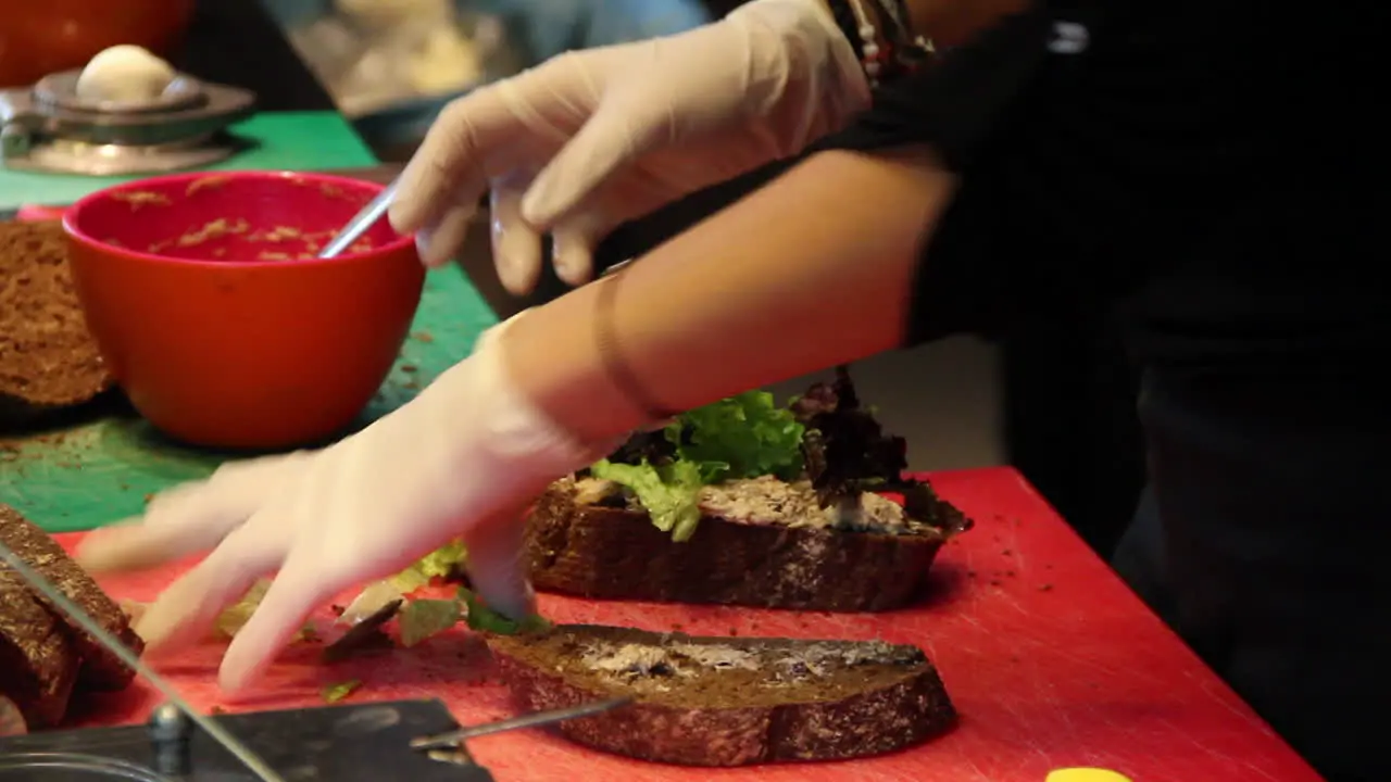 Caterer making tuna sandwich