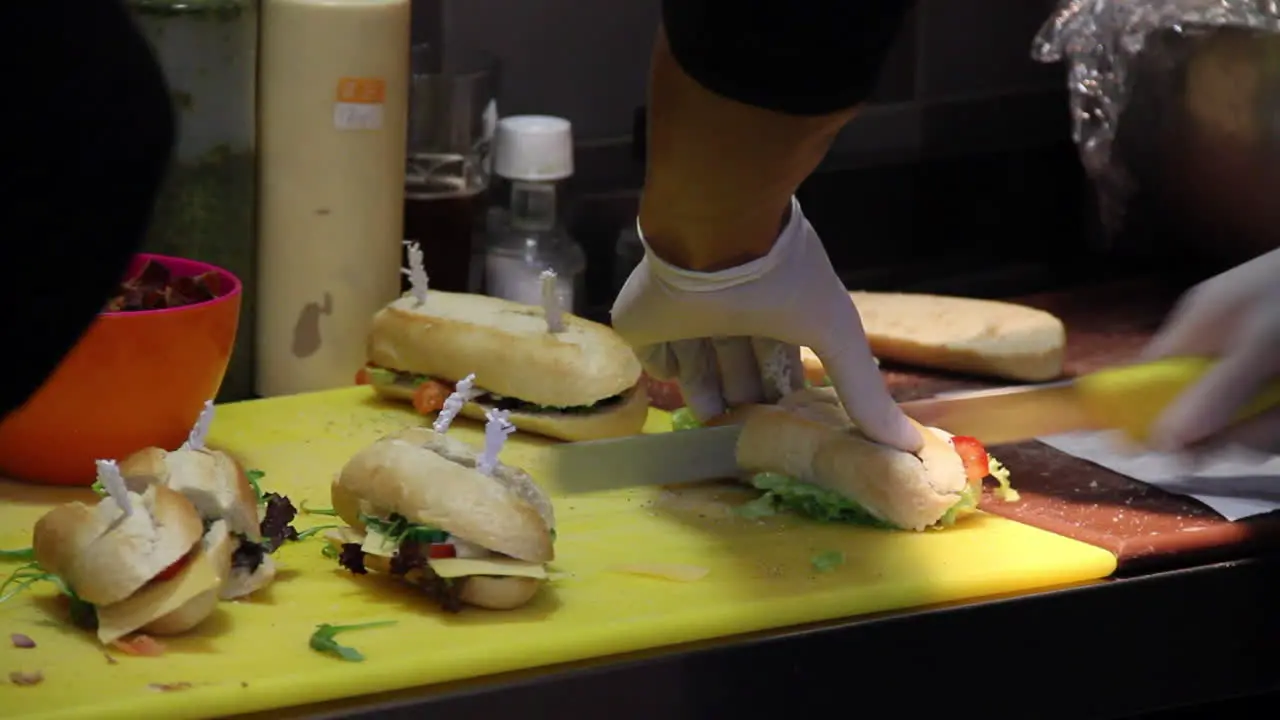 Caterer cutting sandwiches