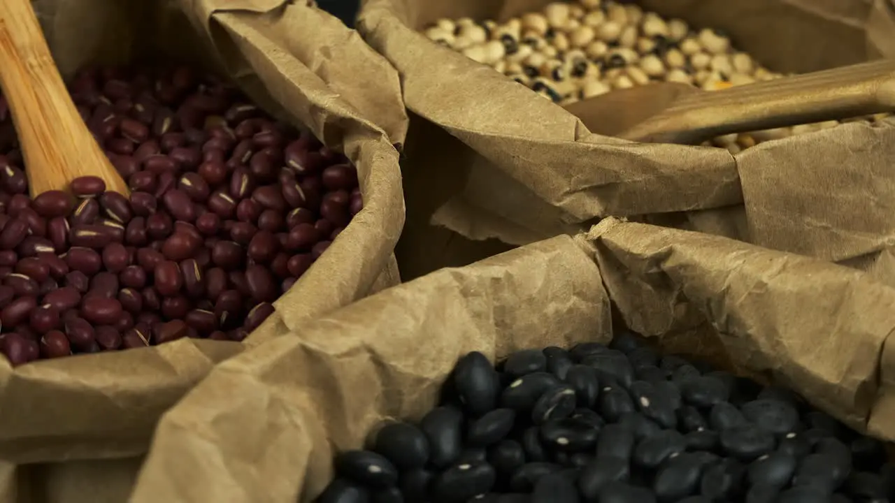 Rich narrow focus close up Assorted dry beans rotating in paper bags