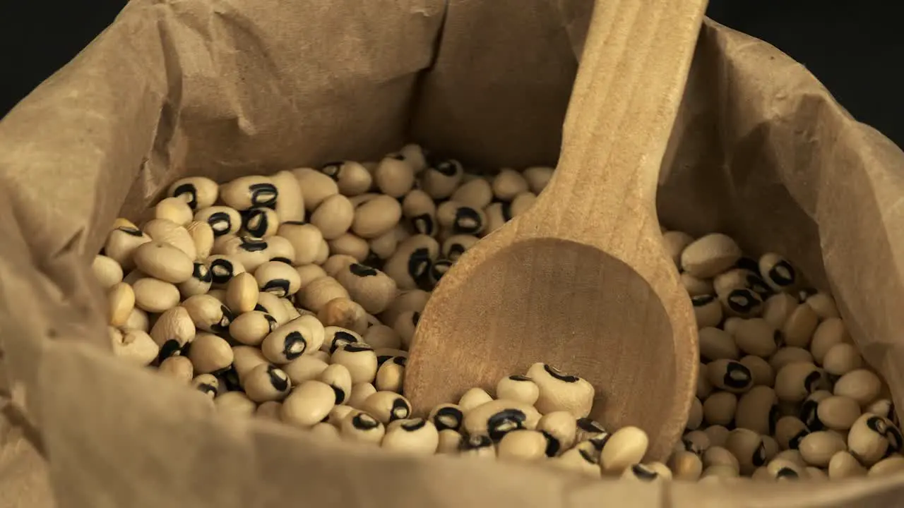 Food detail Paper bag of dried black-eyed peas rotates in close-up