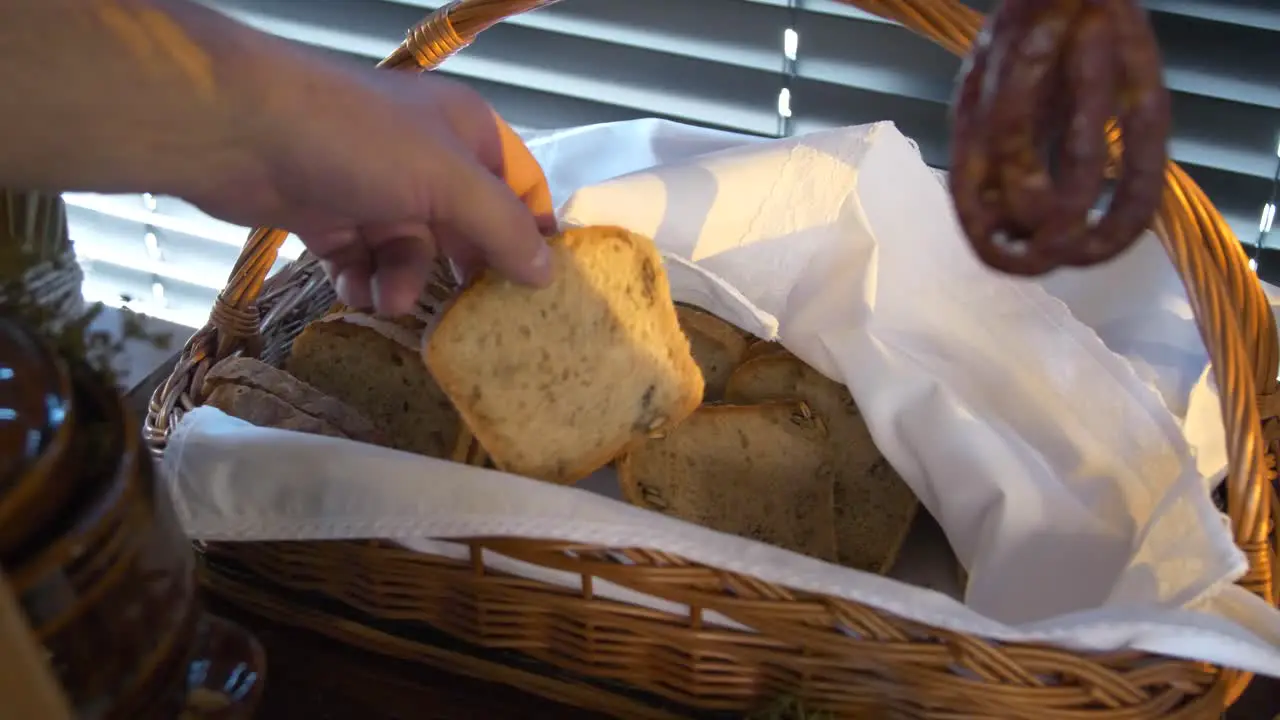 Homemade bread in a wicker basket and smoked ham