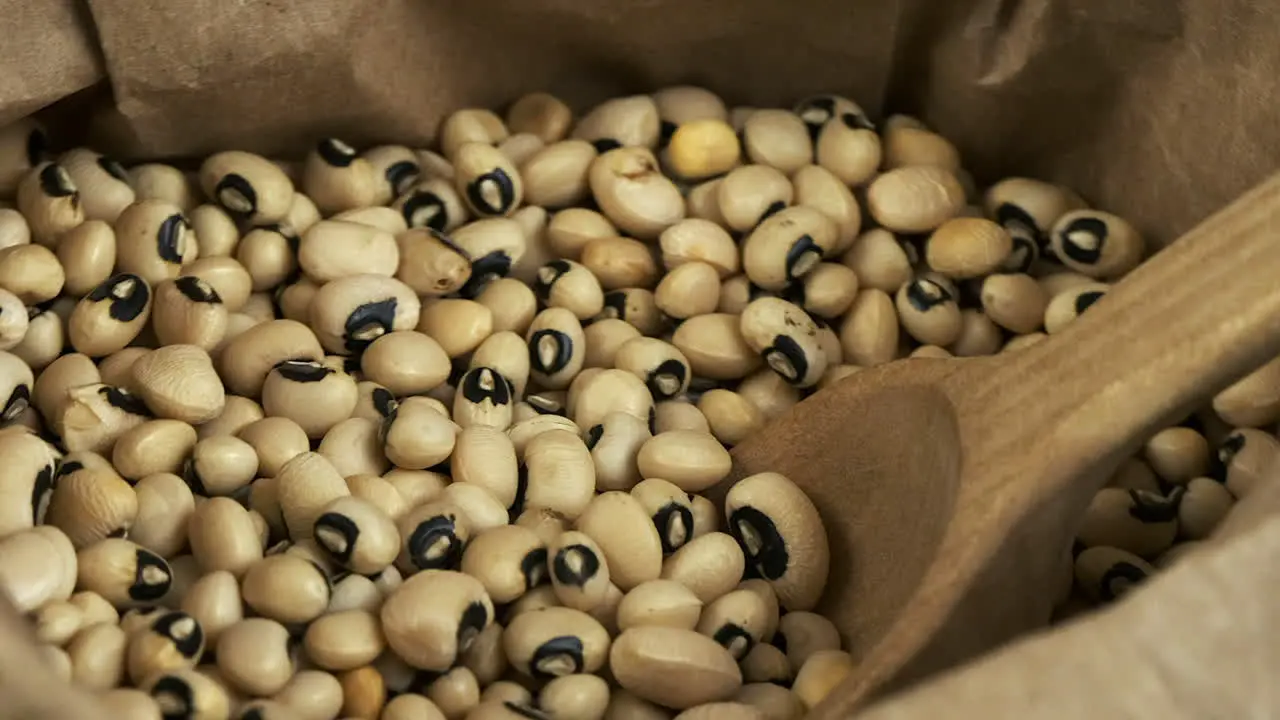 Macro closeup Dry beans healthy black-eyed peas revolve in paper bag