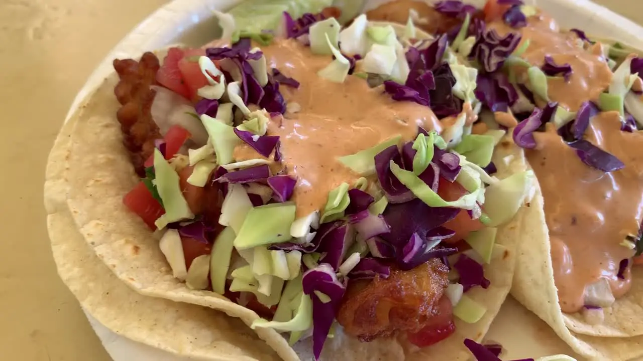 A close-up slow motion video of a plate of fish tacos that will make your mouth water