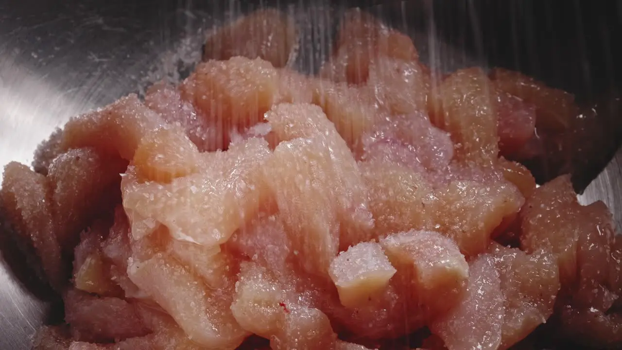 Seasoning Chicken Meat in a Bowl with Salt Pepper and Herbs