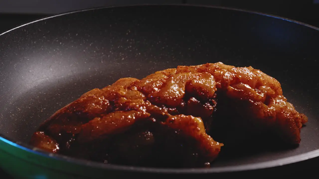 Adding Chicken Breast To A Frying Pan Close-up View