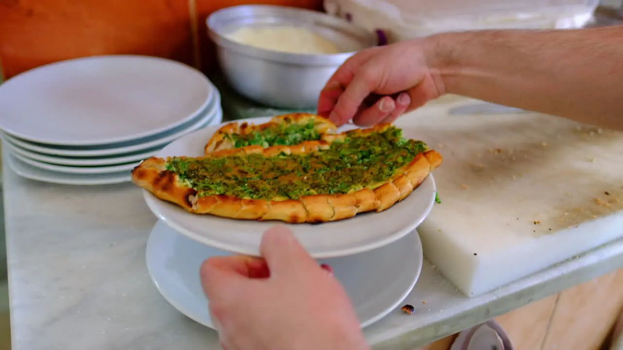 Cheese is poured on the baked pita