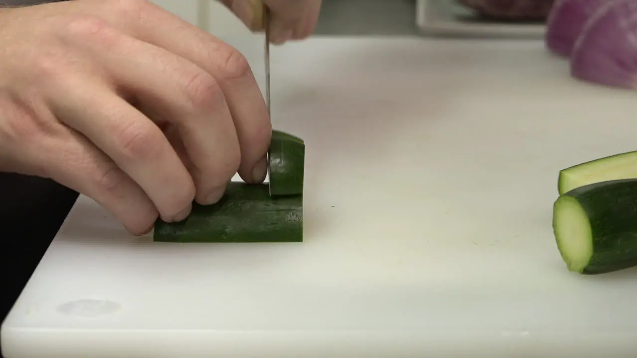 Chef slices zucchini perfectly