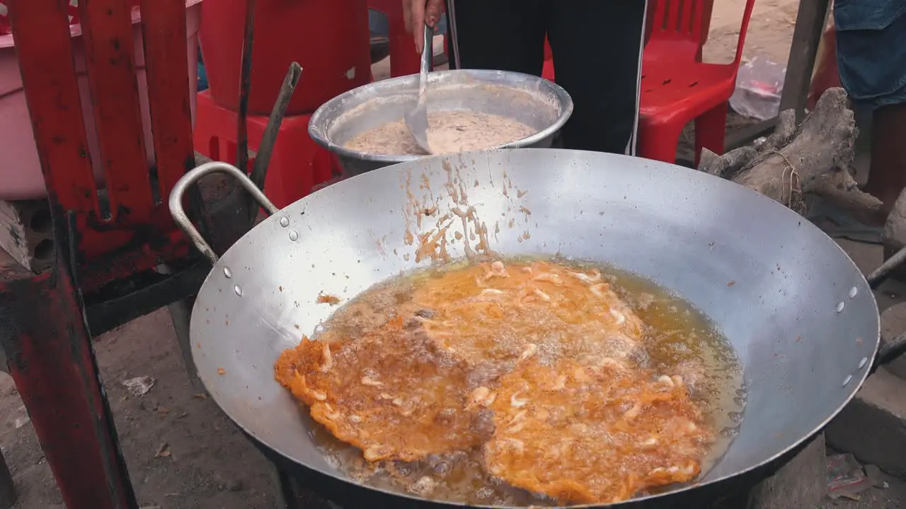 Wide Shot of Shrimp Cakes Frying at the Side of the Road