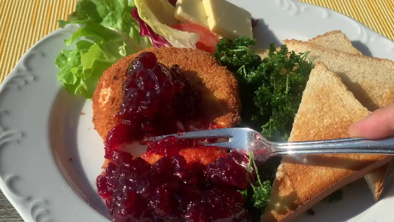 Eating baked camembert with fresh jelly