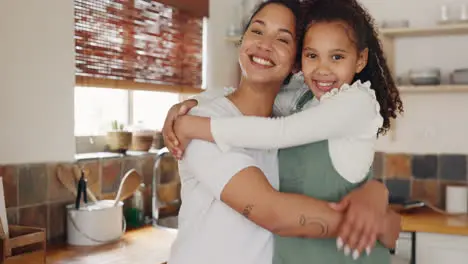 Love mother and girl hug in house kitchen