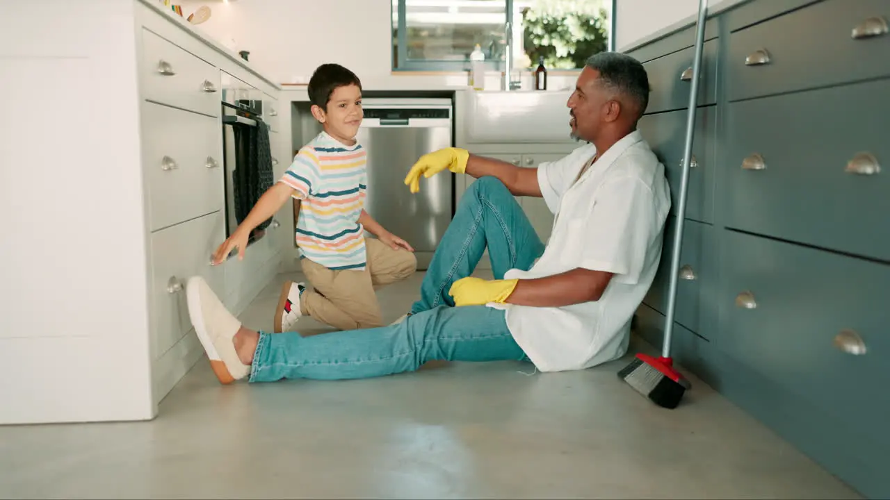 High five dad or child cleaning in kitchen