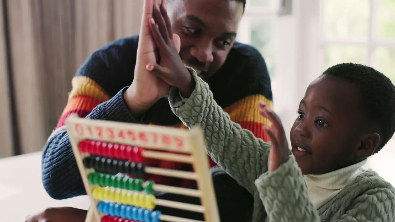 Black family abacus and father high five child