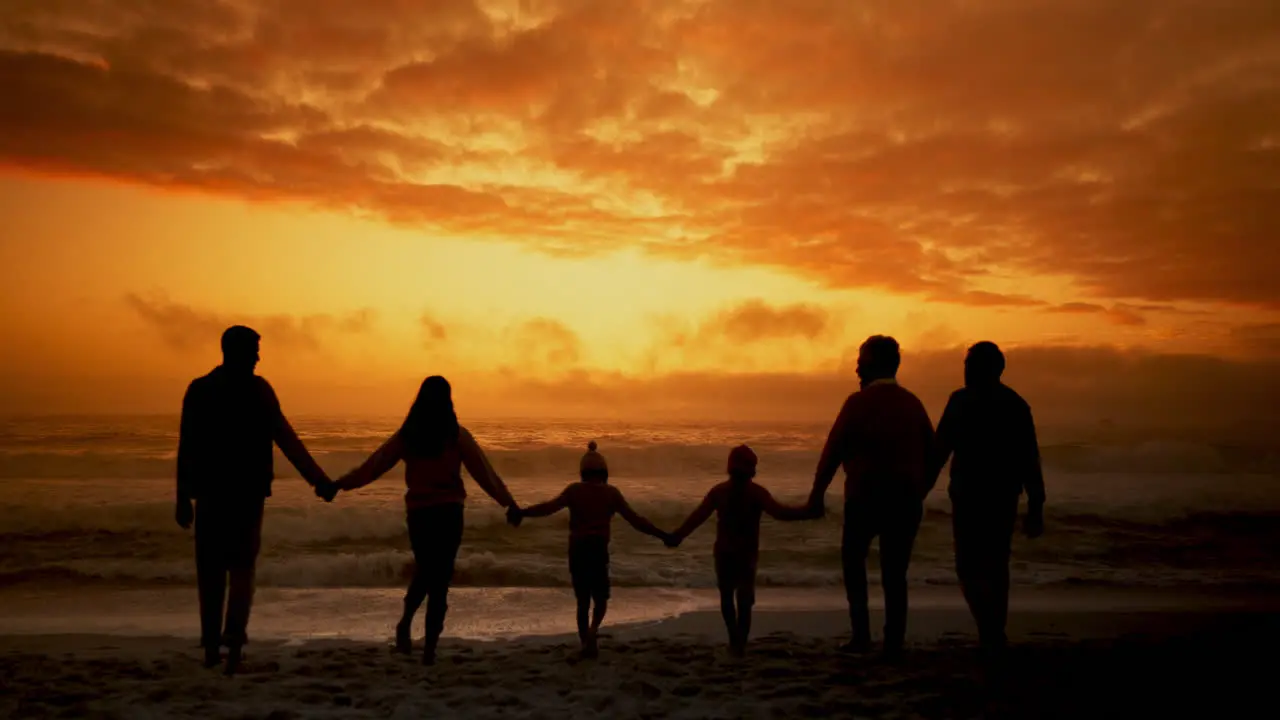 Sunset beach and big family holding hands