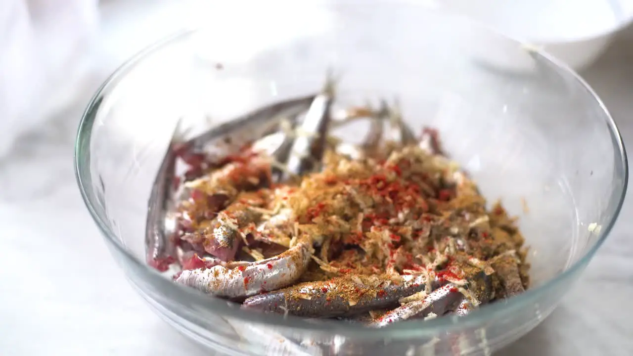 add the spices to the bowl of sardines