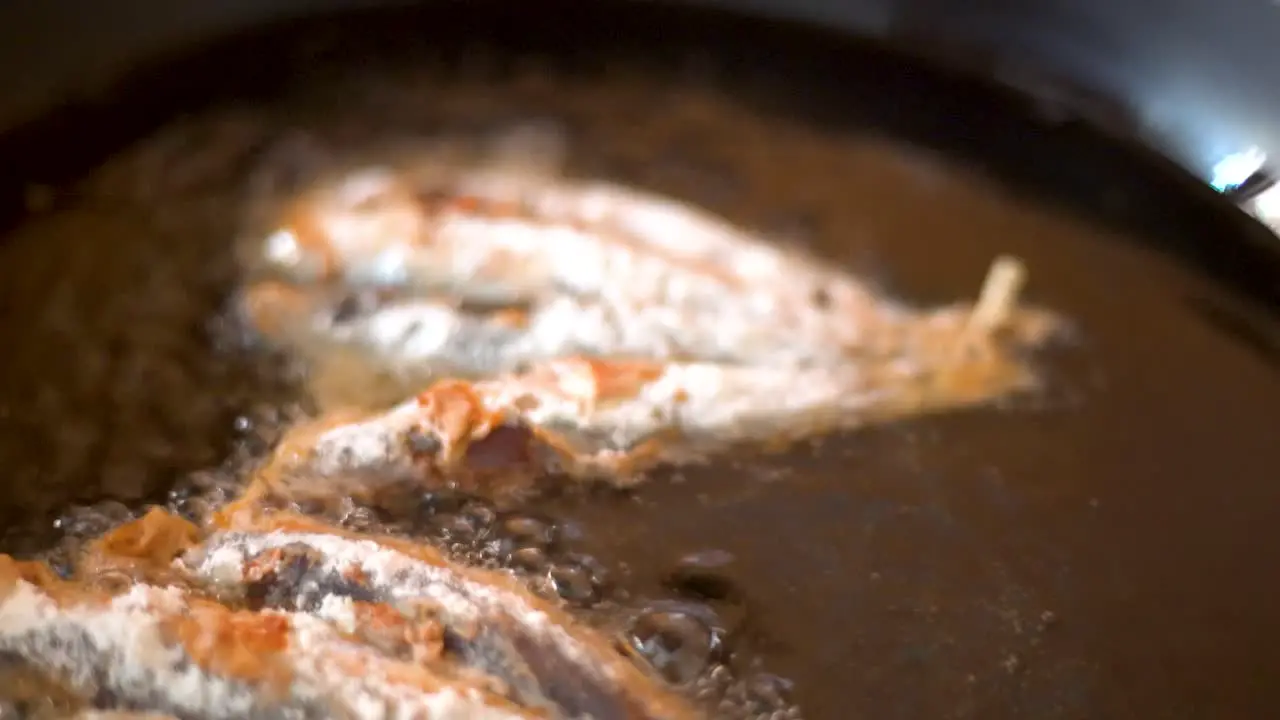 frying sardines in a pan