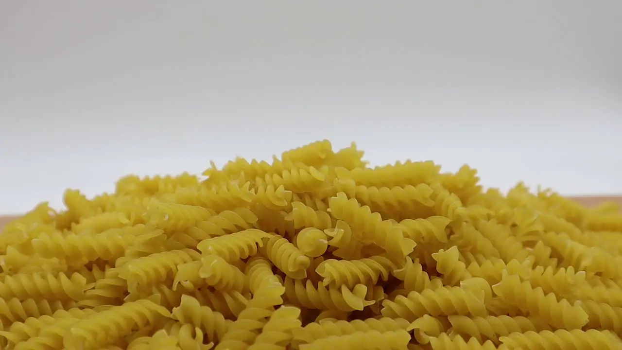 Raw Fusilli on wooden table Traditional italian pasta