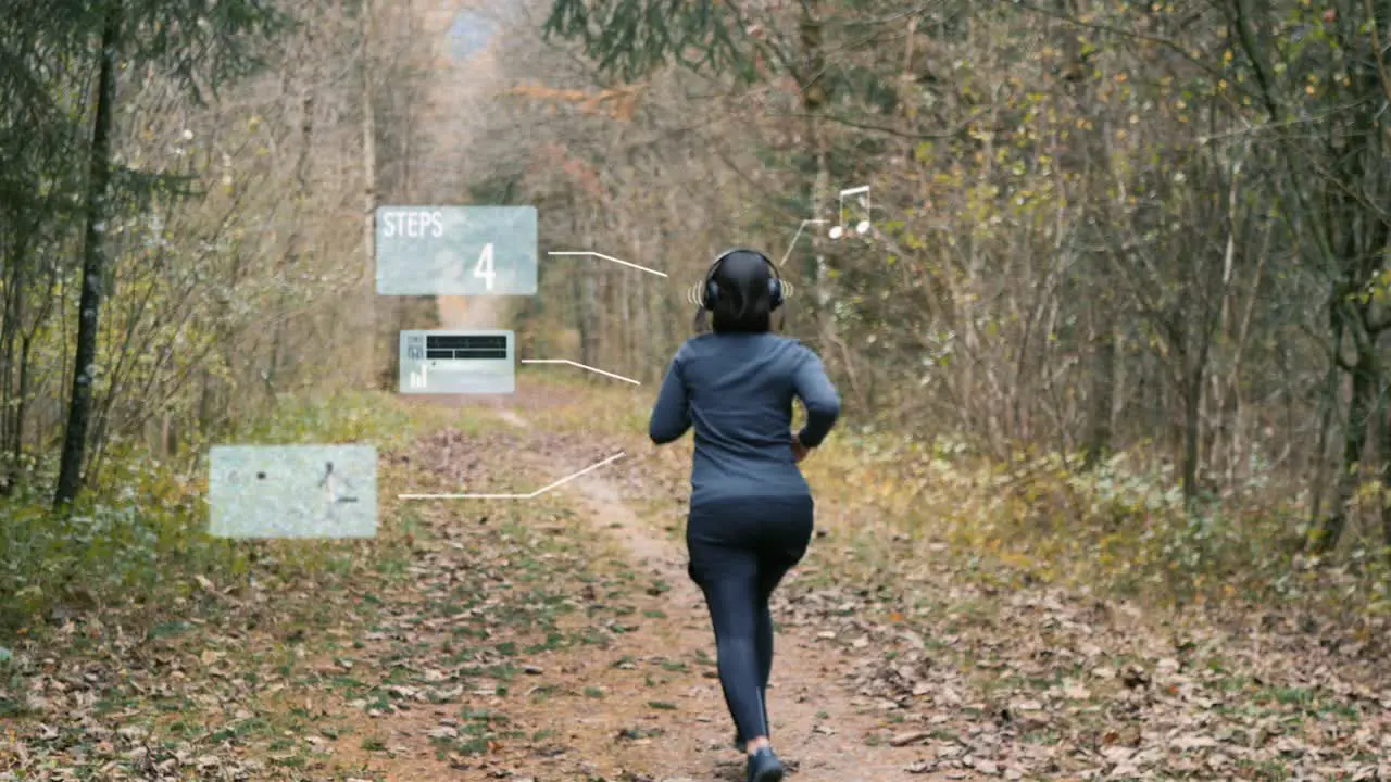 Sporty woman puts on headphones and activates fitness app on her smartwatch for running through the autumn forest Animated holograms insert