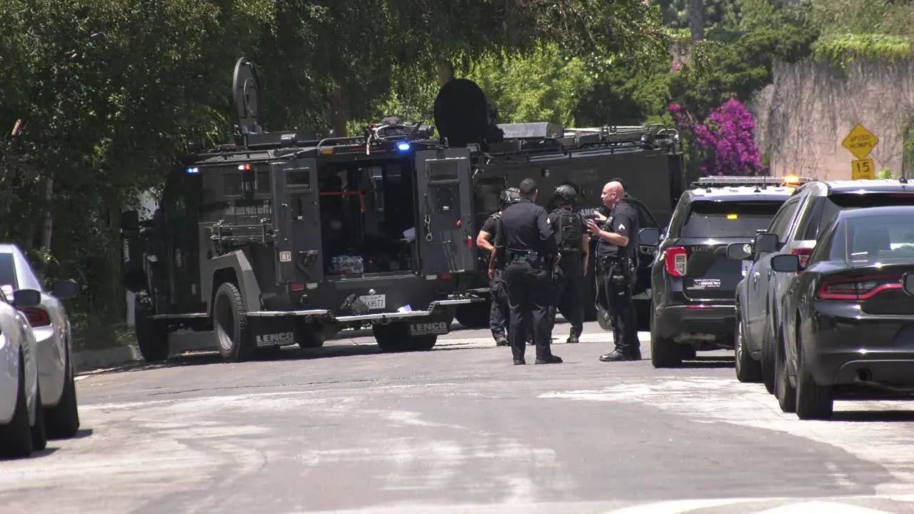 swat vehicles on barricade scene