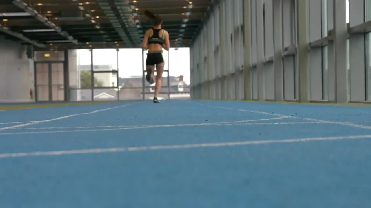 Woman racing on indoor track