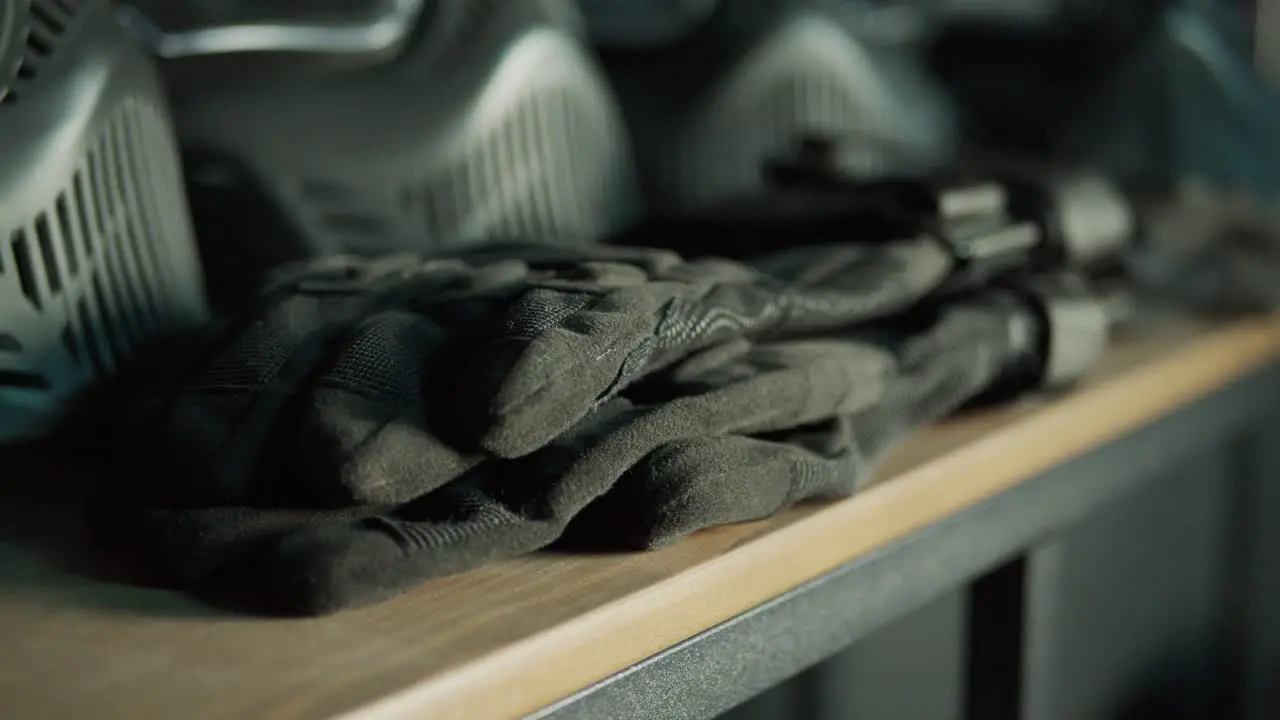 A figure removes gloves from a shelf