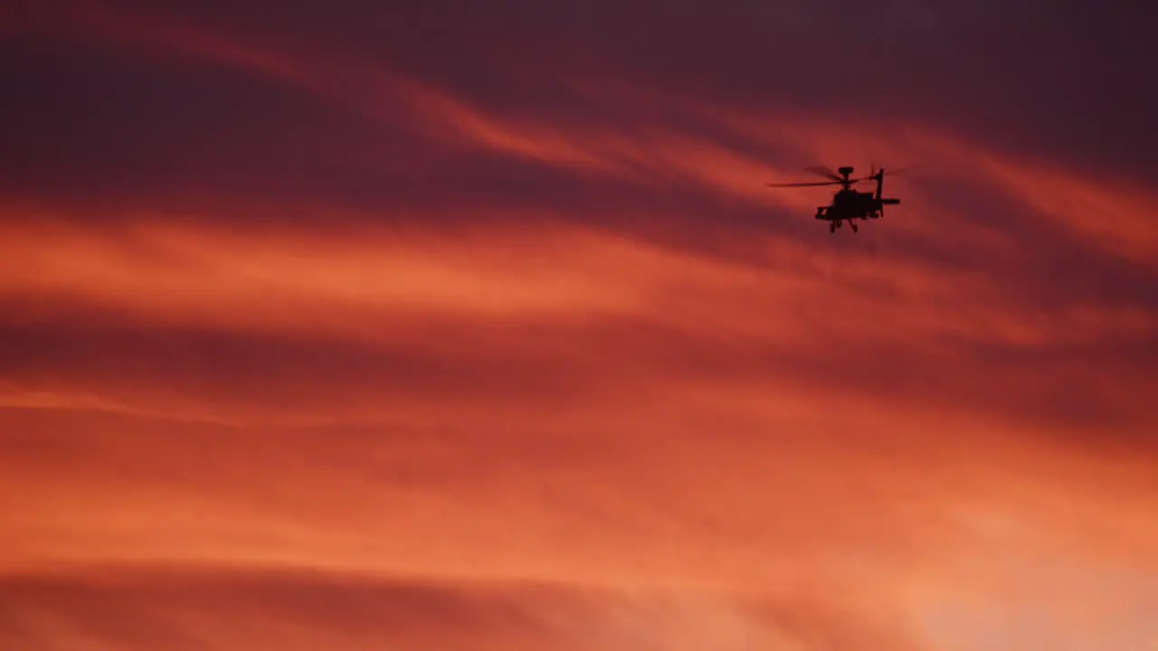 Military Helicopters Firing Machine Guns Into The Opponent At Battlefield At Sunset