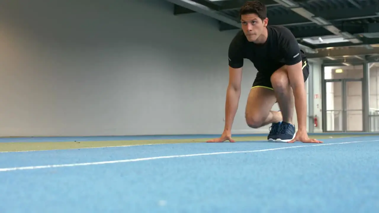 Man racing on indoor track