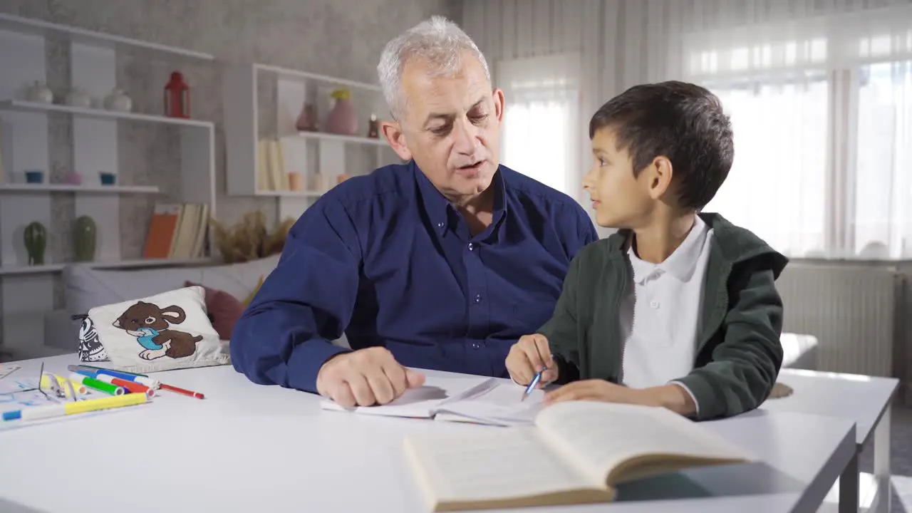 Father looking after and helping his son who is studying