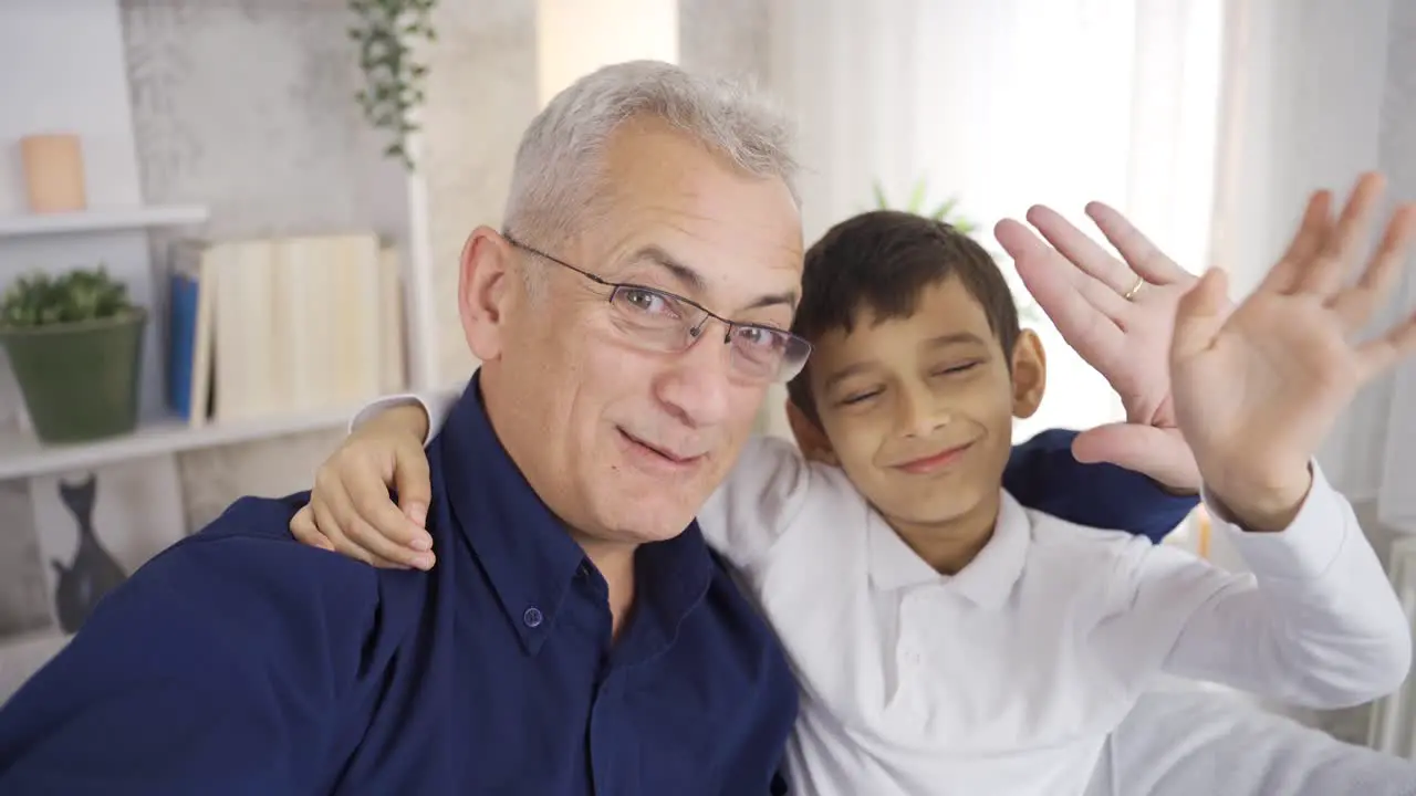 Father and son talking on the phone together at home