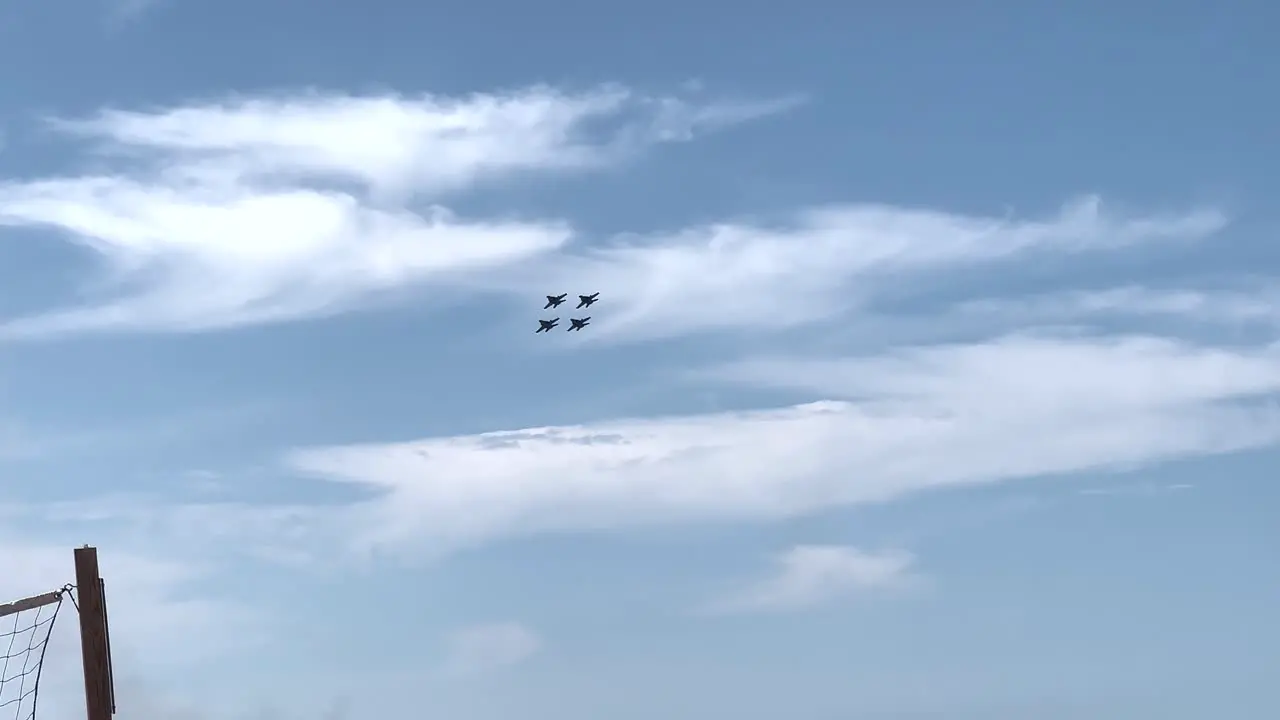 Four Blue Angel jets flying in formation over Grand Traverse Bay in Traverse City Michigan