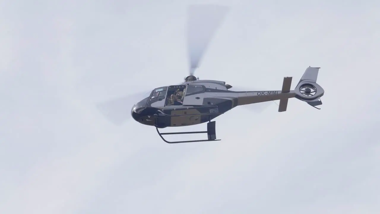 Military Special Units Helicopter With Soldier in Open Cockpit Flying in the Sky Low Angle View