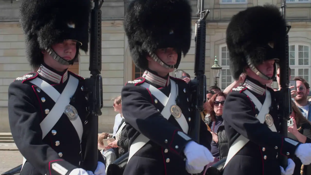 Royal guards in uniform marching at a ceremonial event