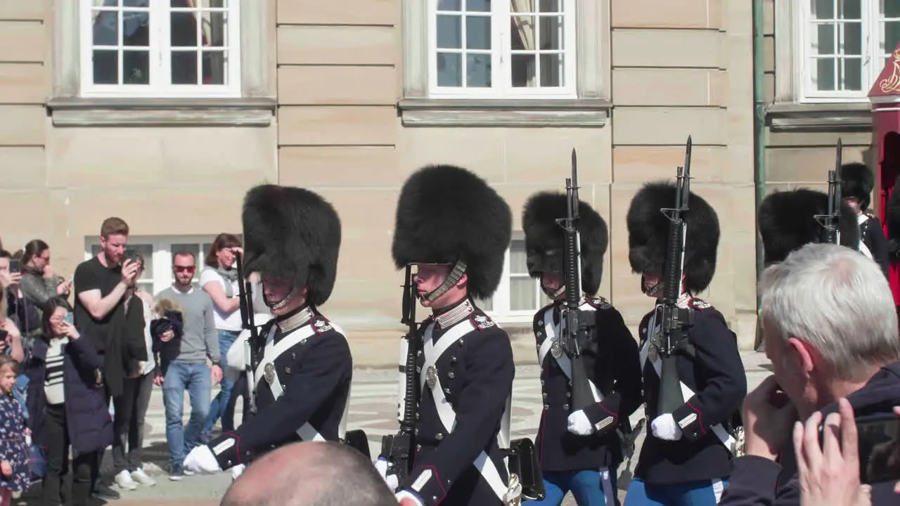 Royal Danish Guard in formation with onlookers capturing the moment