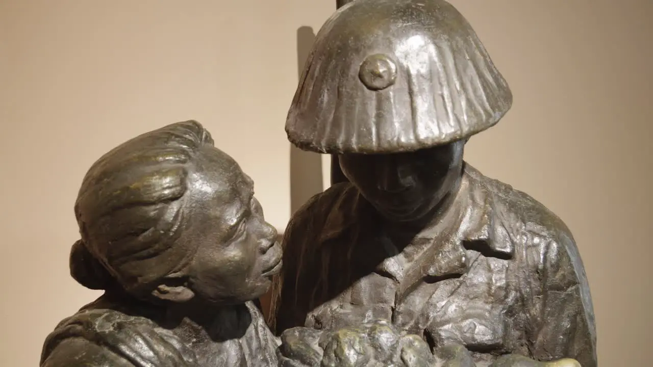 A moving sculpture depicting a mother offering a bowl of rice to her son a soldier located in the Vietnam Military History Museum in Hanoi Vietnam