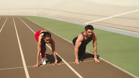 Fitness couple training together at stadium Sport couple running together