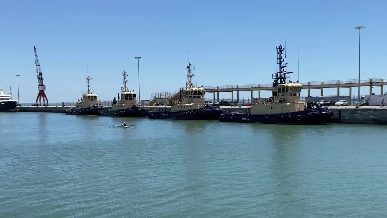 some armed forces ships on the river with some sportsmen doing canoeing Alcântara Portugal