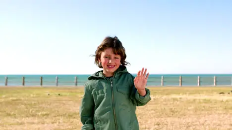 Child boy or waving by beach