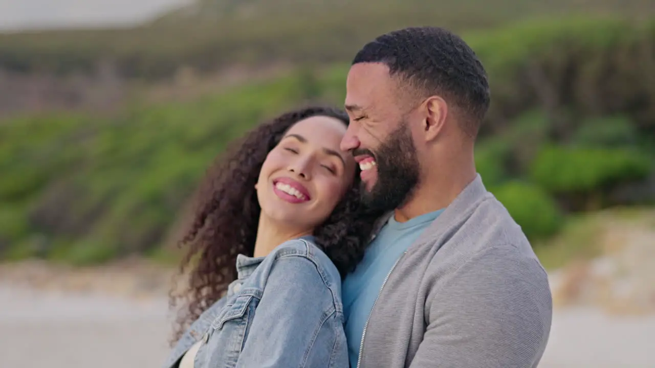 Happy love and couple hug on beach at sunset