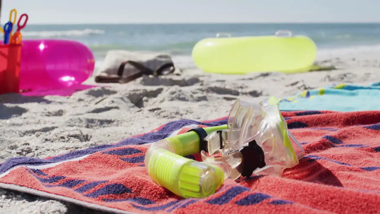 Video of snorkeling mask towels and beach equipment lying on beach