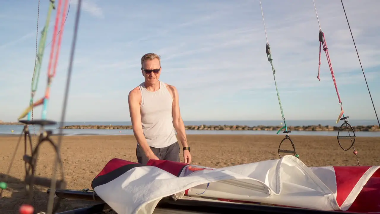 man preparing the candle of a hobie cat