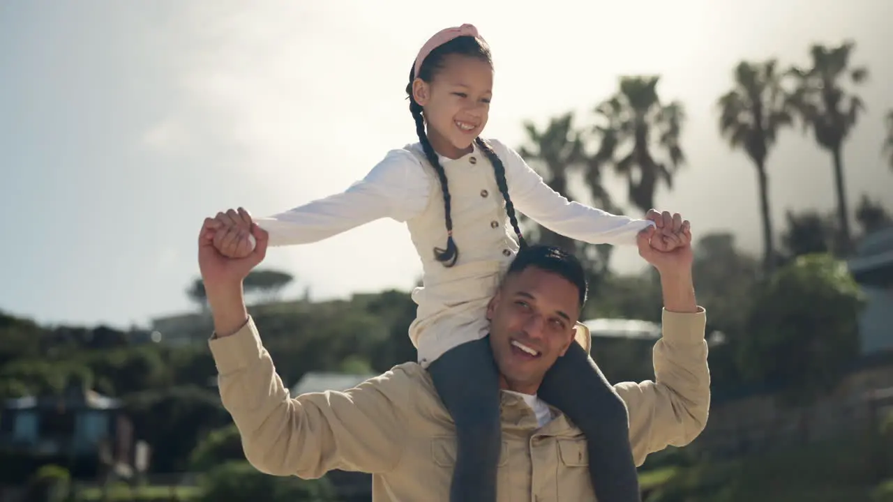 Beach walking and father with child on shoulder